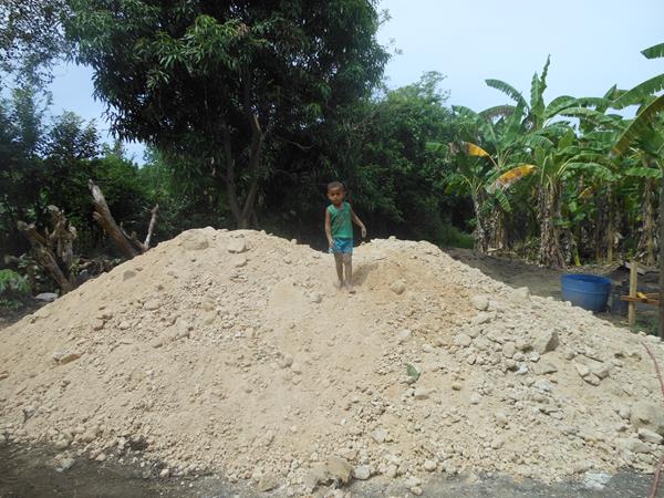 child on pile of sand