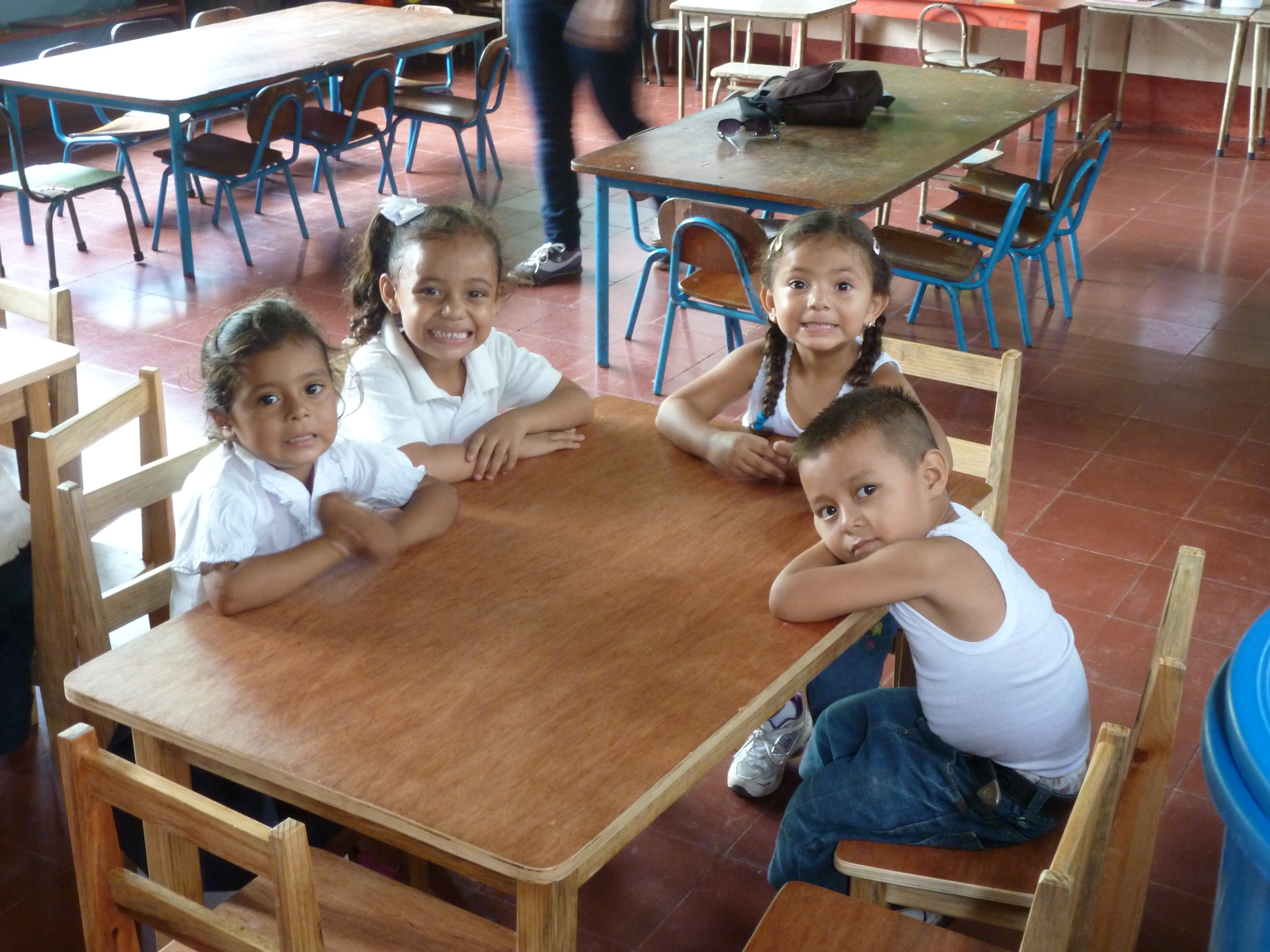 Children in one of the Montessori schools in Puerto Morazán with their new tables and chairs which were made locally and financed by a generous donor in England